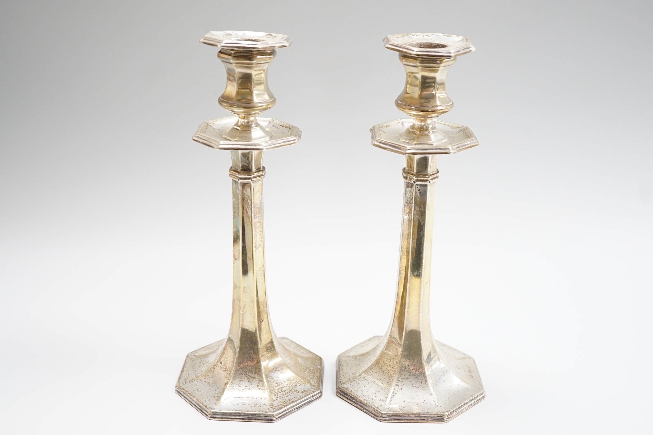 A pair of George V silver mounted candlesticks, with panelled stems, by James Dixon & Sons, Sheffield, 1913, height 21.8cm, weighted.